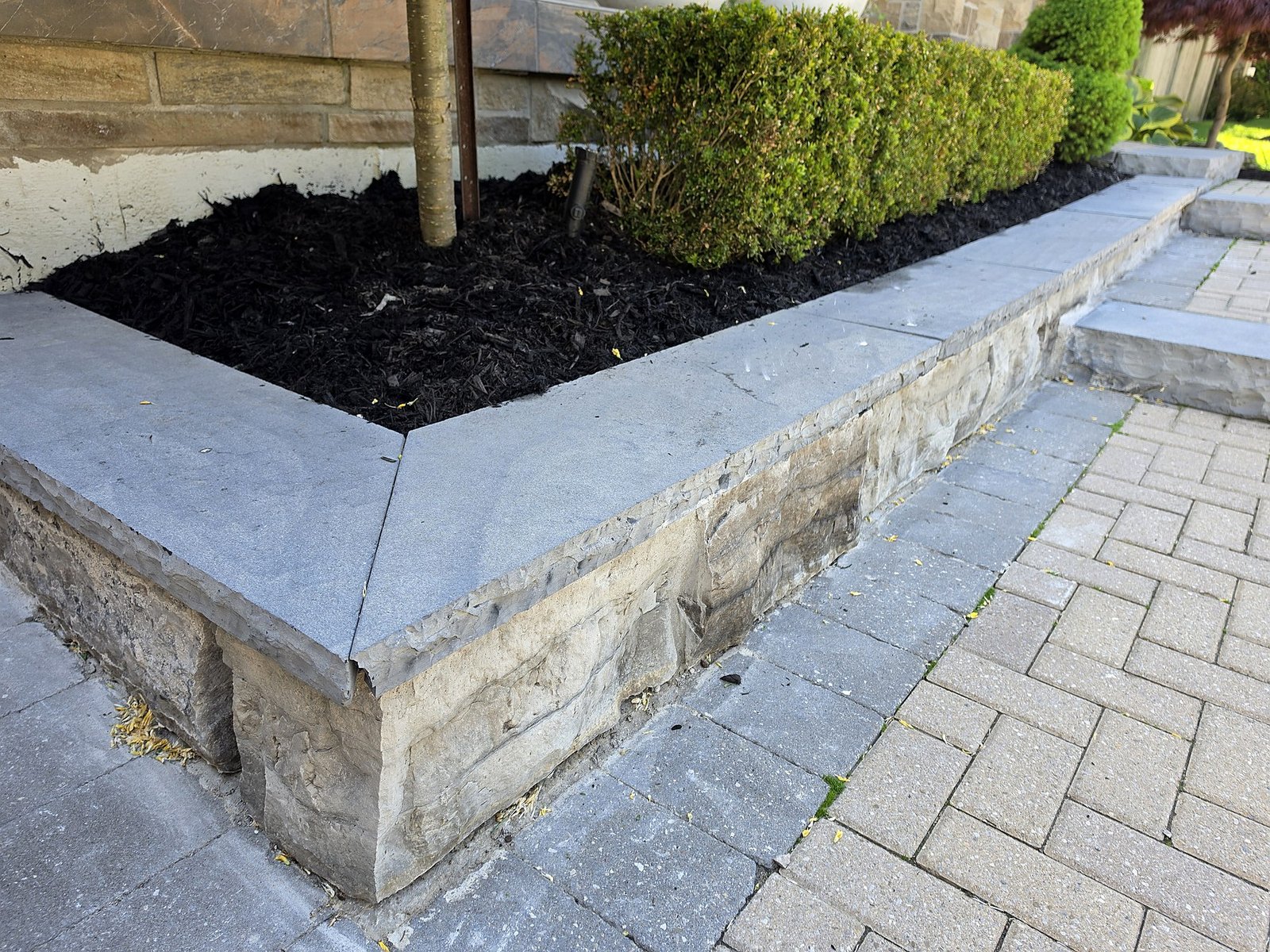 Finished masonry retaining wall